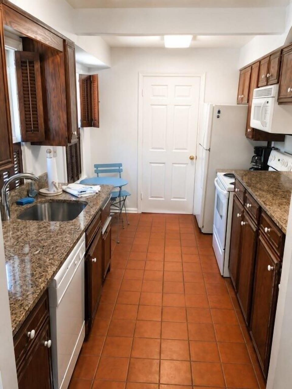 Galley kitchen with granite counters