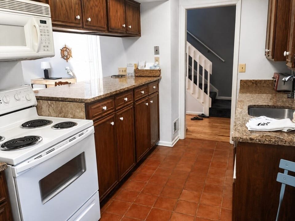 Full galley kitchen with cooking basics supplied