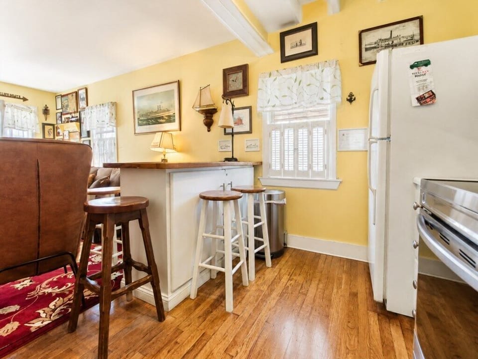 Hardwood floors and a breakfast bar create an easy flow between the kitchen and living room.