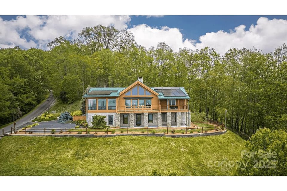Exterior Escape: Experience mountain serenity in this stunning cabin with expansive decks and lush views!
