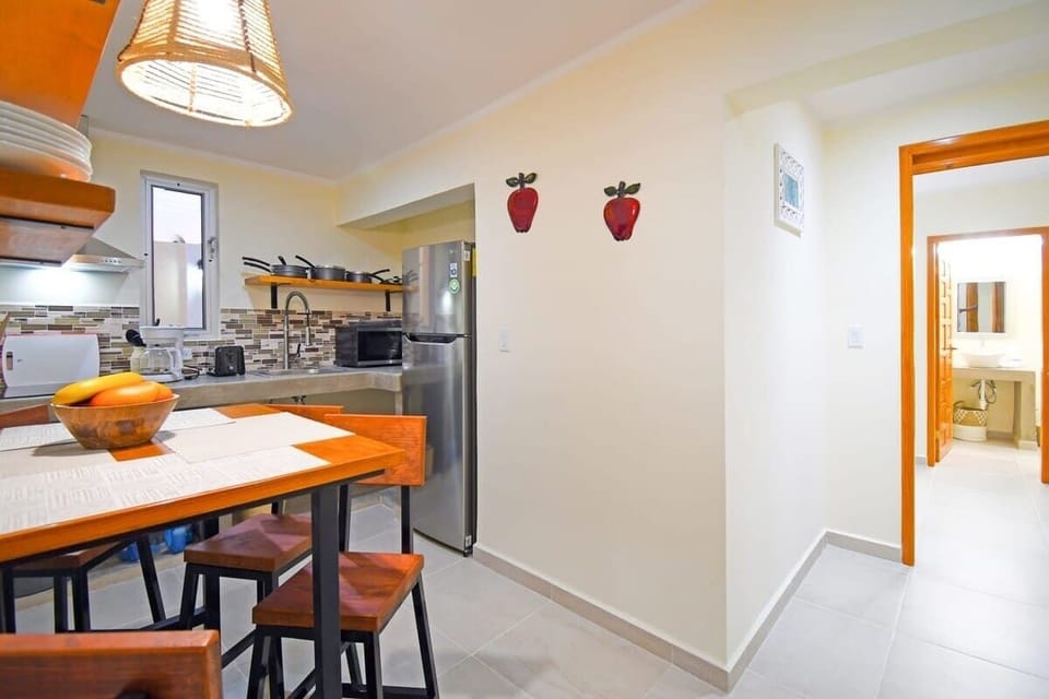 A 4-seater high-top table & kitchen as you walk in