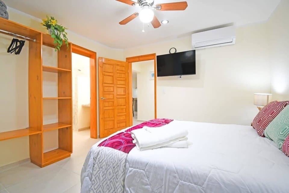 Bedroom 2 also with a wall-mounted Smart TV & a closet with hangers!