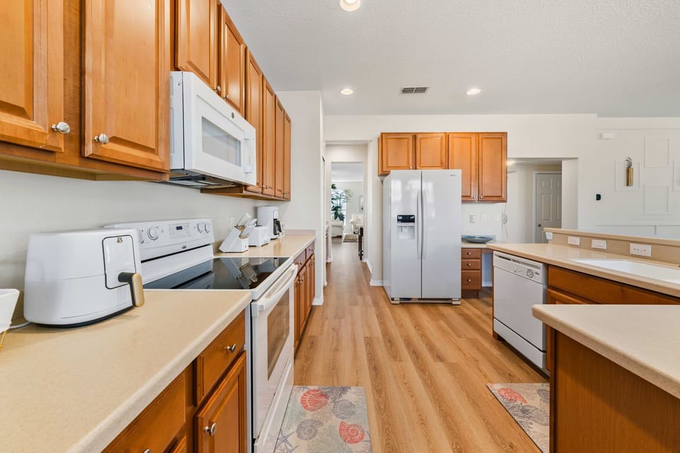Spacious kitchen with wooden cabinets and modern appliances