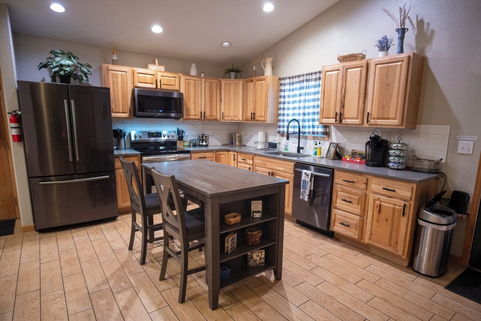 Our kitchen is fully stocked with pots, pans, many appliances, and a coffee bar.