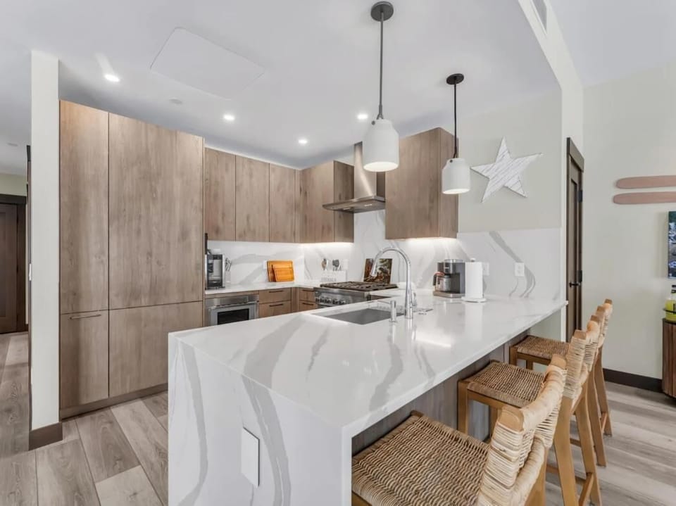 Sleek kitchen with marble island and cozy bar seating