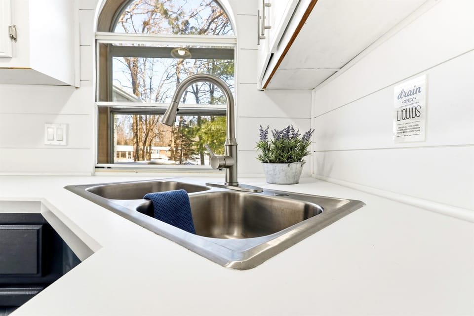 Functional kitchen with a double sink, combining style and practicality.
