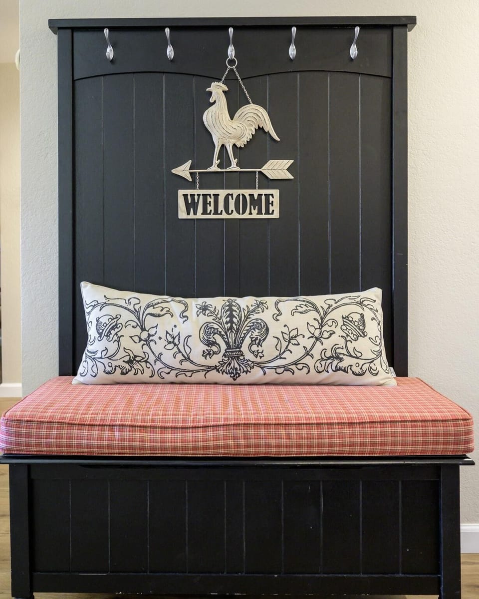 Cozy entryway bench with charming rustic welcome sign