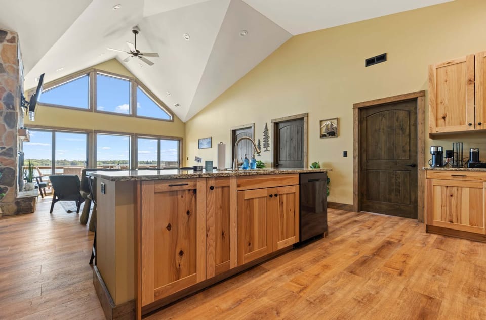 The kitchen is an open concept layout with the dining area and upper level living room.