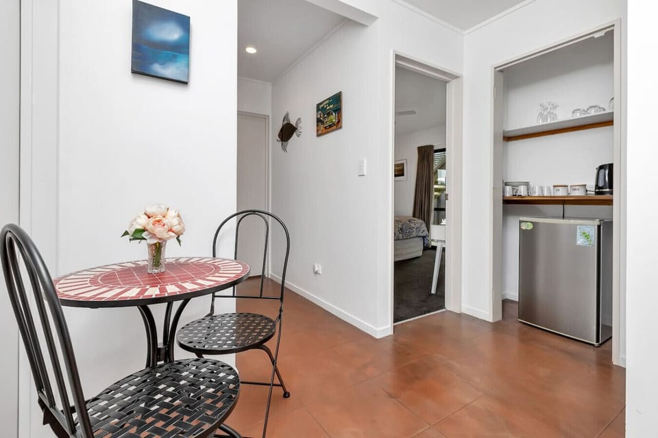 Kitchenette storage area with mini fridge, essentials, and small dining table