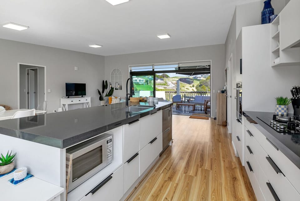 Spacious open-plan layout connecting kitchen, dining, and lounge