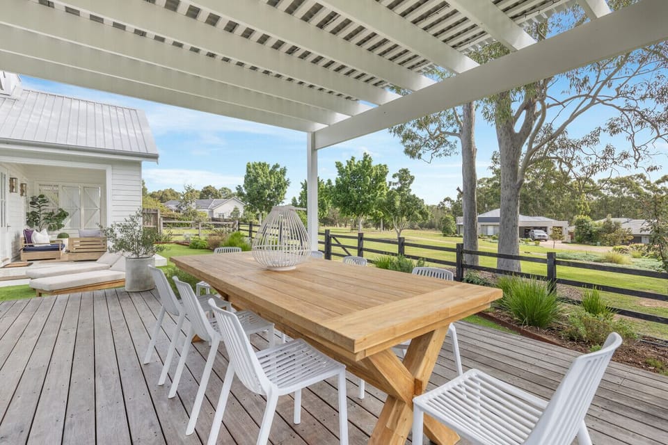 Undercover outdoor dining deck, directly off the kitchen and living room. Garden, parkland, pool and golf course views. Perfect for all day dining and watching the sun set.