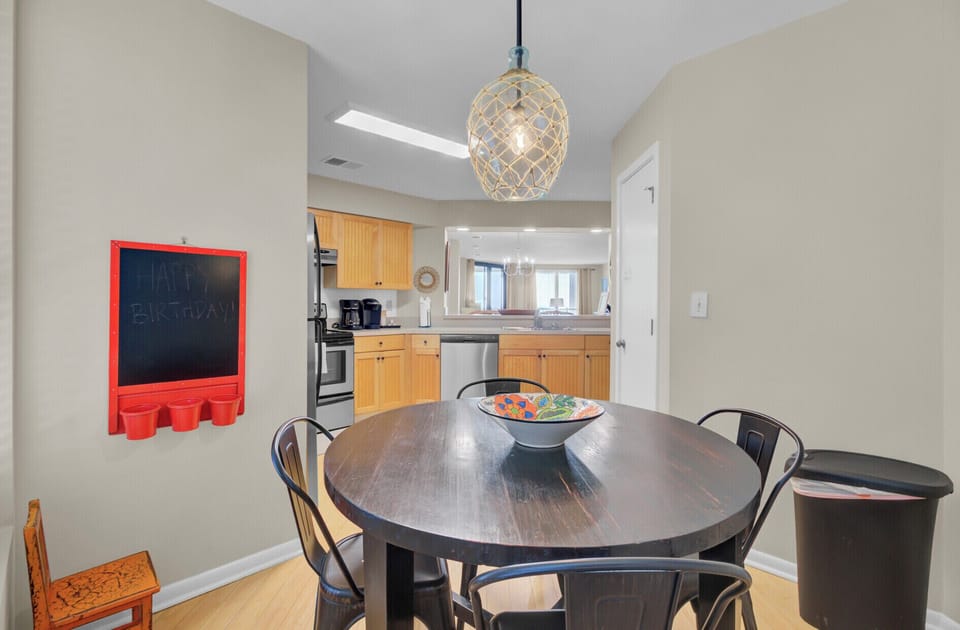 Circular breakfast table with the kitchen in the background.