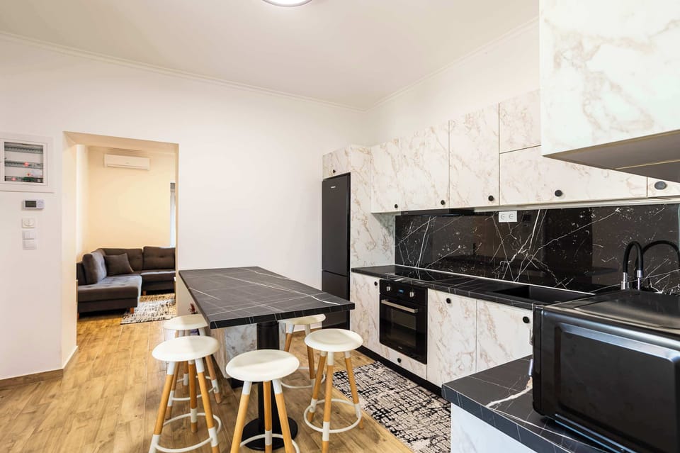 Open kitchen with dining space and bar stools.