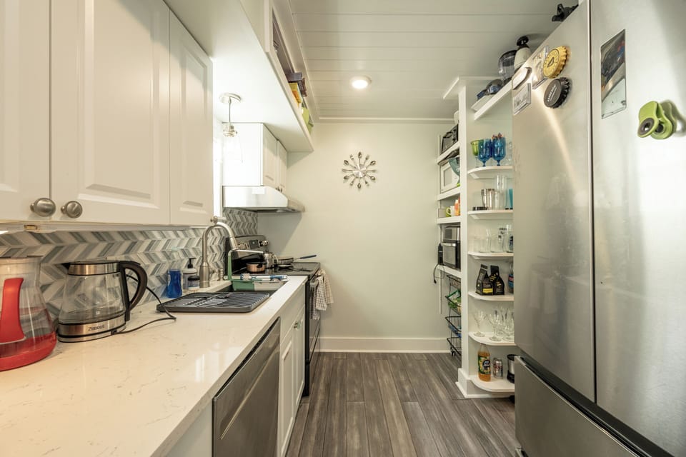 Galley kitchen area, second full bath to the right