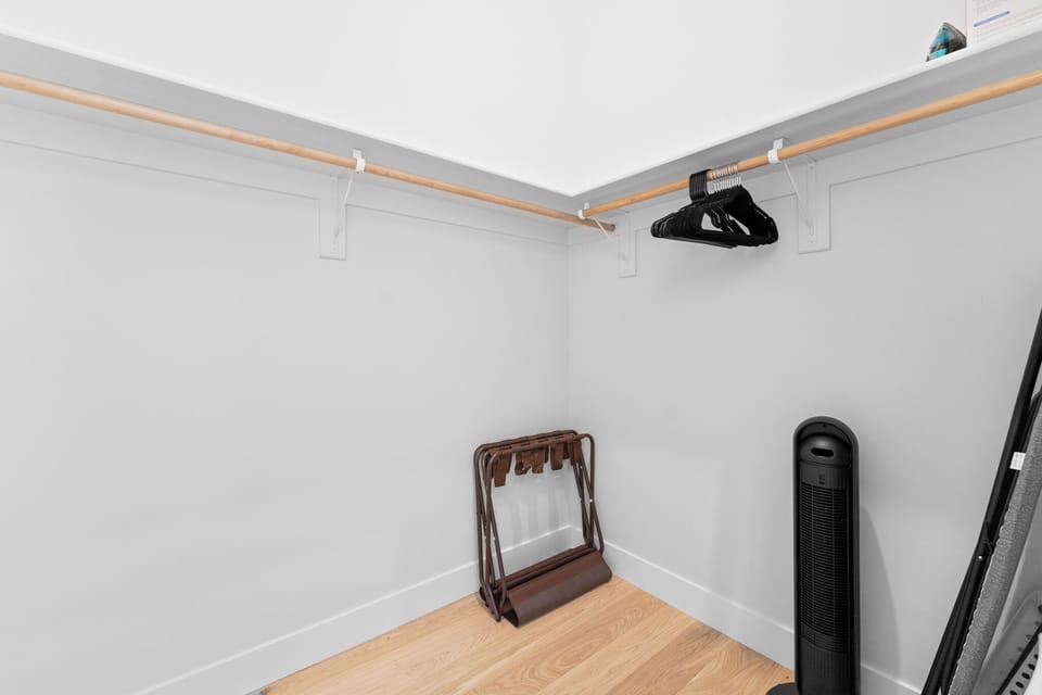 Primary en suite bathroom with a dual sink vanity, walk-in shower, and walk-in closet.