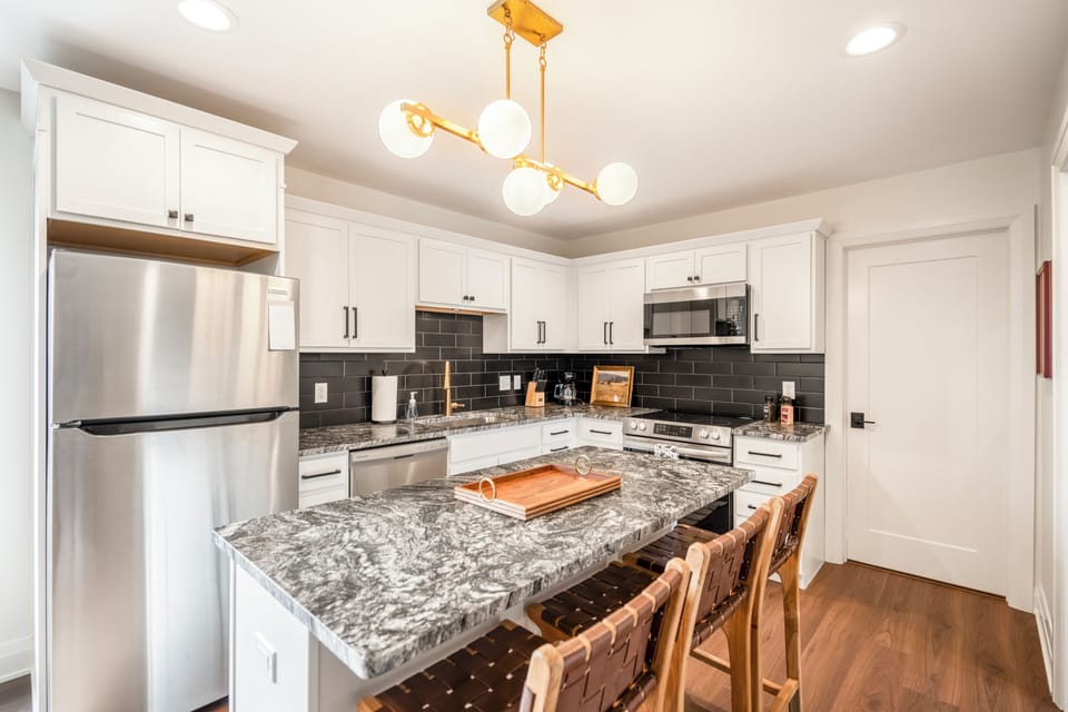 Cook and dine comfortably in the full kitchen with island seating. Enjoy a thoughtful welcome basket with coffee, chocolates, dishwasher pods, and helpful guide! 