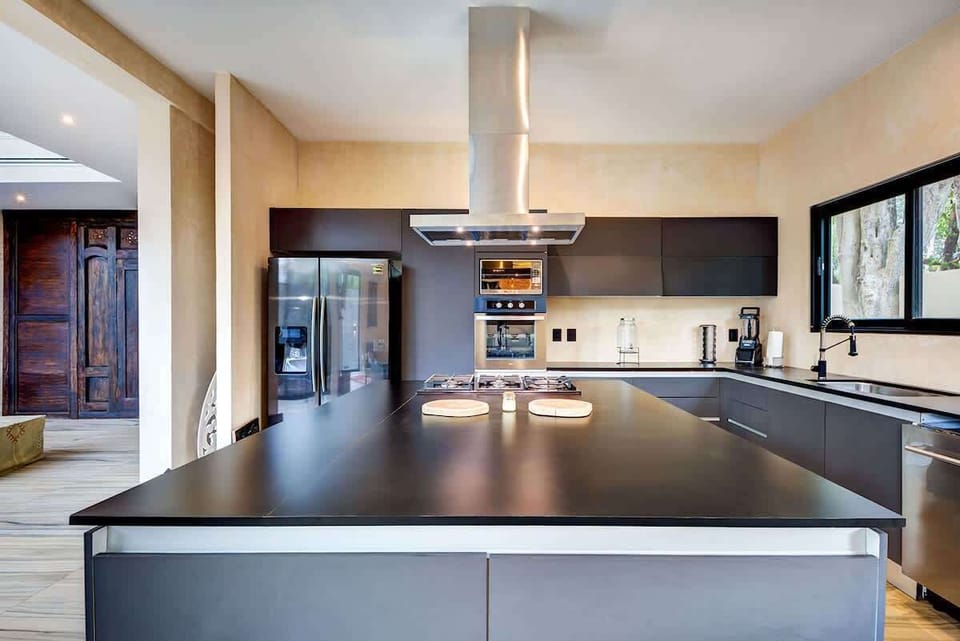 Fully equipped modern kitchen with large refrigerator and chef-grade appliances.