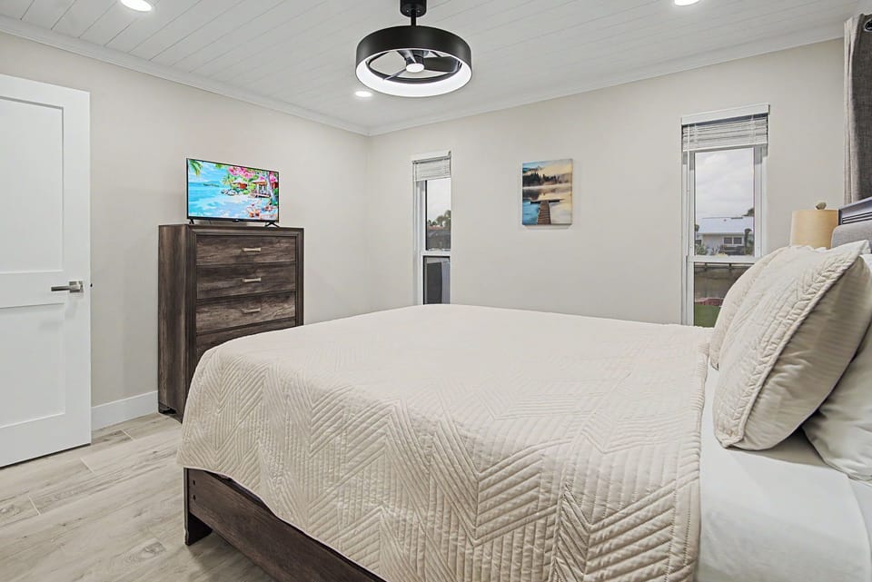 Sink into soft linens and unwind in your cozy bedroom, with calming décor, a ceiling fan, and peaceful neighborhood views to help you rest easy.