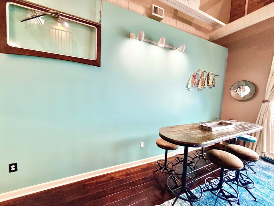 A closer look at the dining area, featuring bar-height seating and coastal accents. Ideal for shared meals, morning coffee, or planning your day along Lake Erie.