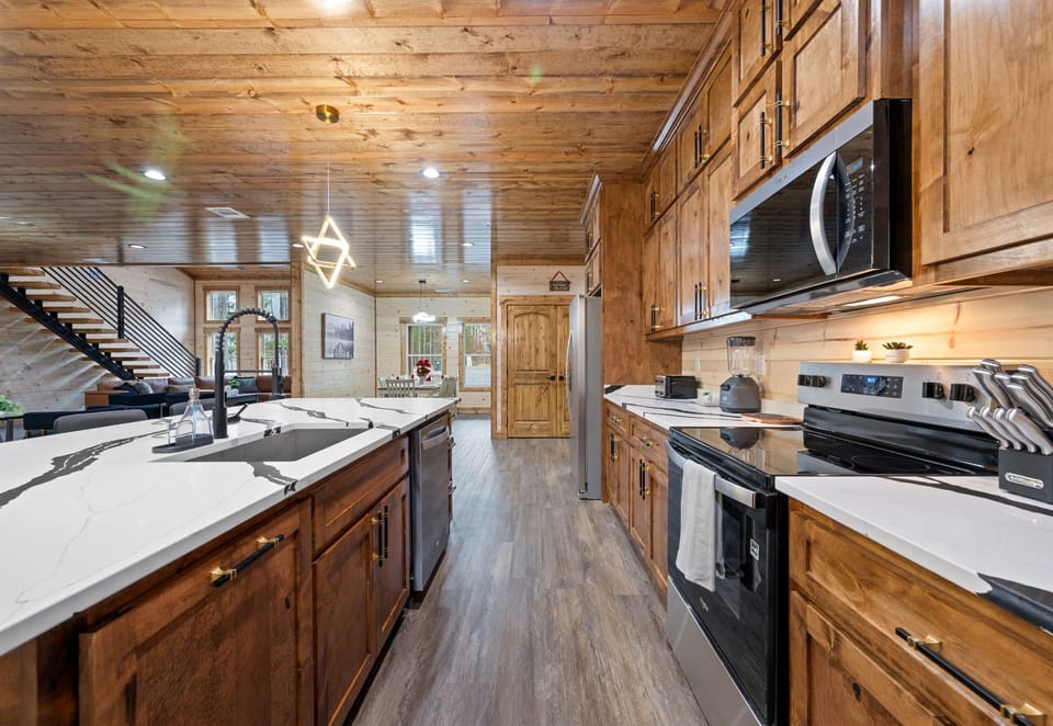 The kitchen stretches out with ample cabinetry and workspace, giving everyone plenty of room to help with cooking.