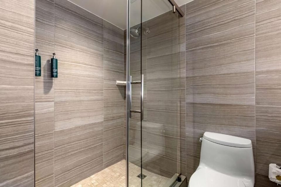 Refresh under a sleek glass shower after a busy day.