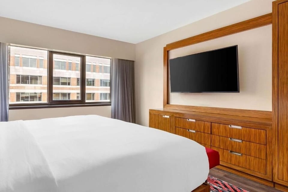 Relax with in-room entertainment and daylight streaming through windows.