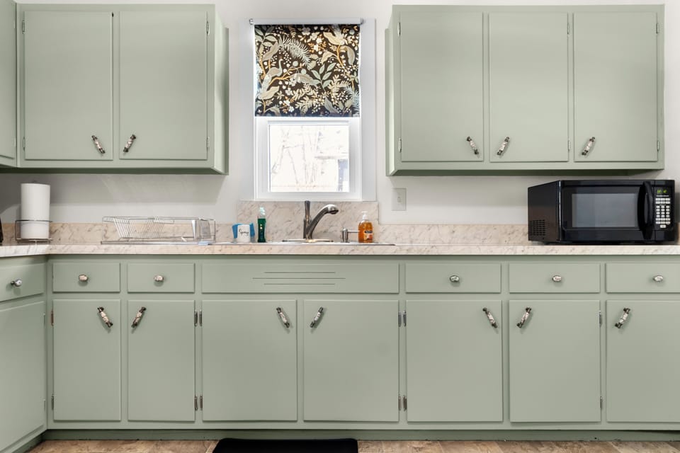 Fully equipped kitchen with ample cabinets for easy home cooking.