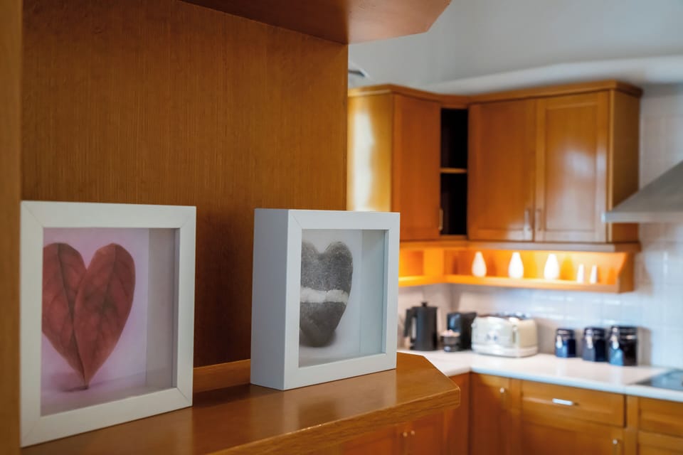 Artistic heart-shaped decor adds charm to a stylish and homely kitchen.