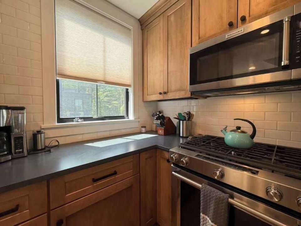 Stainless appliances, warm wood cabinetry, and a gas range make this a kitchen that's actually worth cooking in.