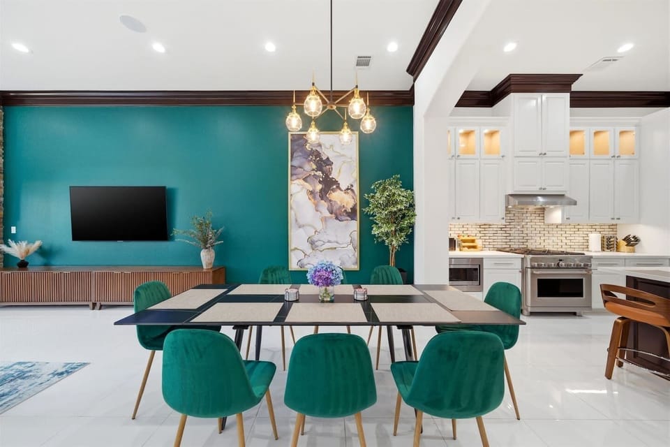 Spacious dining area with seating for eight, open to the chef’s kitchen and large living room, creating the perfect space for meals, games, and gathering together.