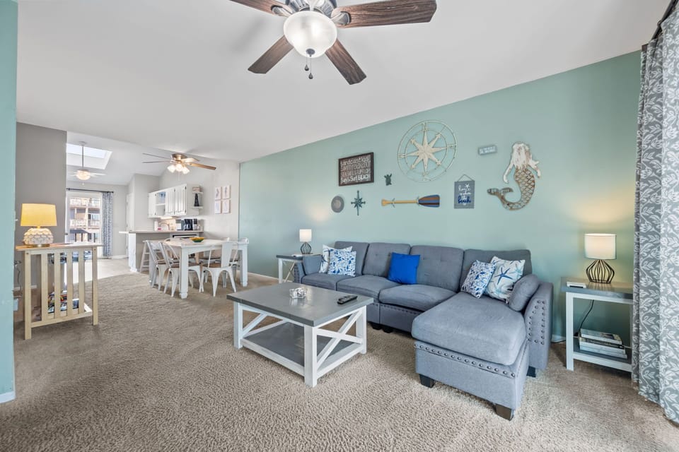 Relax in a bright beach inspired living space with plenty of room to spread out, unwind, and plan the next seaside adventure
