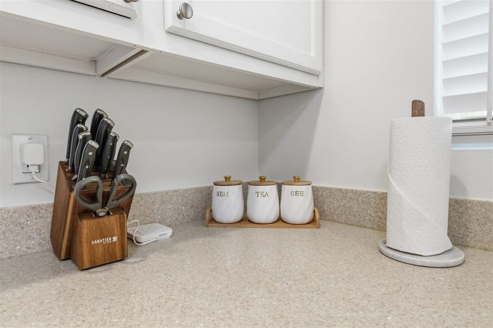 Fully stocked kitchen with knives, spices, and cooking essentials