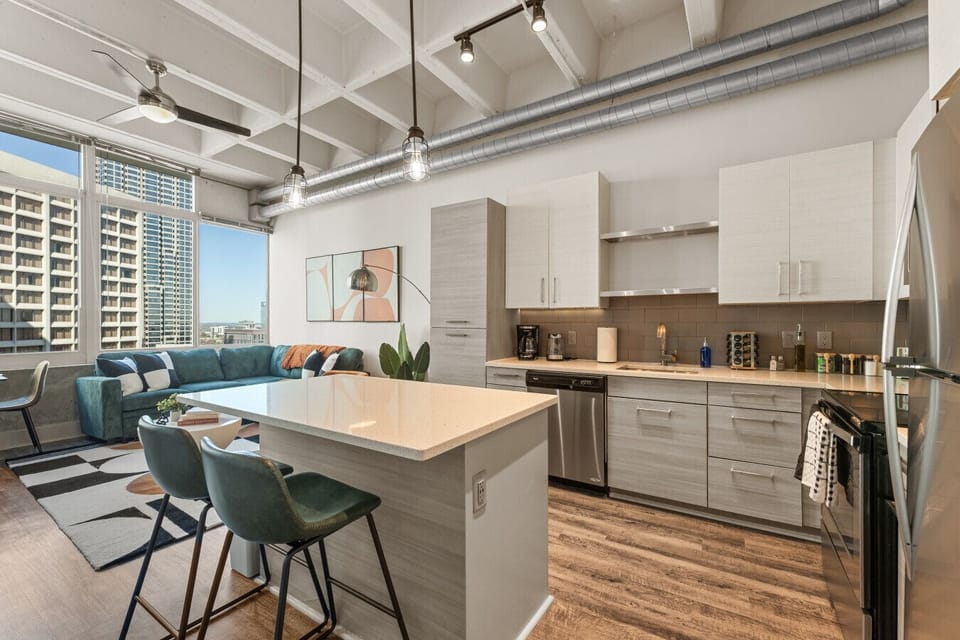Modern Kitchen & Living Space: Bright, open layout with stylish decor and city views awaits!