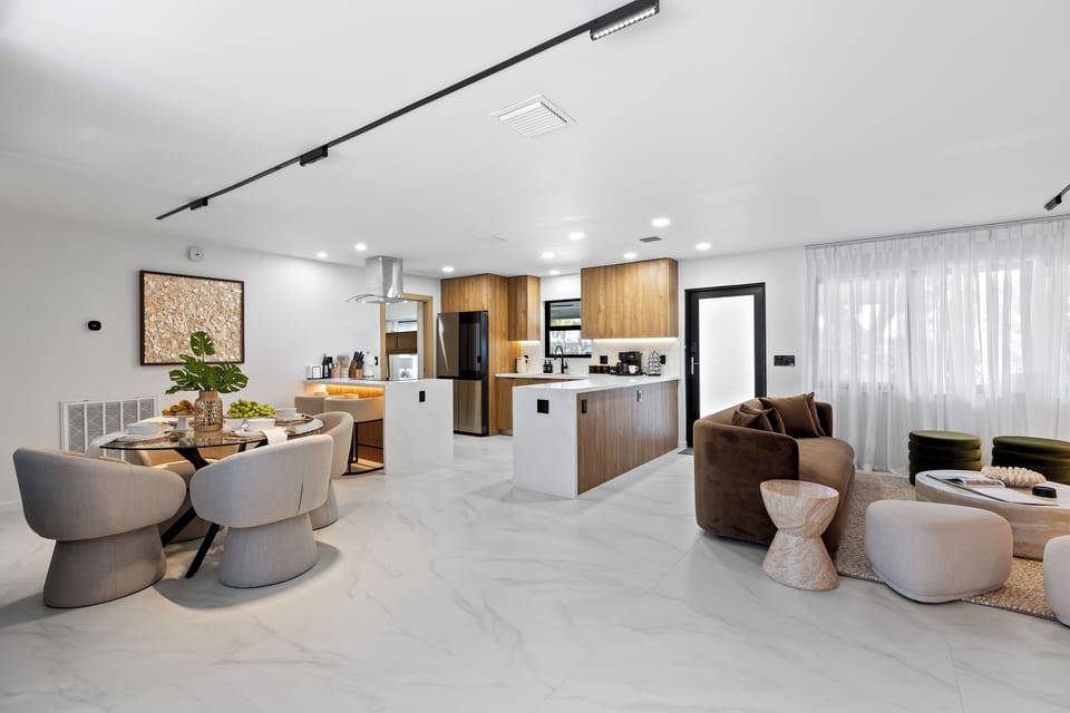 Open-concept kitchen, dining, and living area with a clean modern design.
