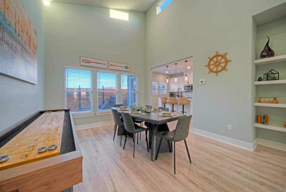 A shuffleboard table adds a fun bonus to the open living space for easy nights in.