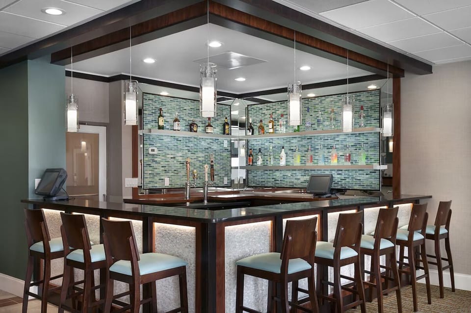 Unwind with handcrafted drinks at the sleek, inviting bar.