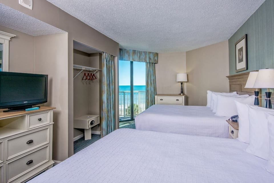 Unwind in crisp twin beds with soothing ocean views.