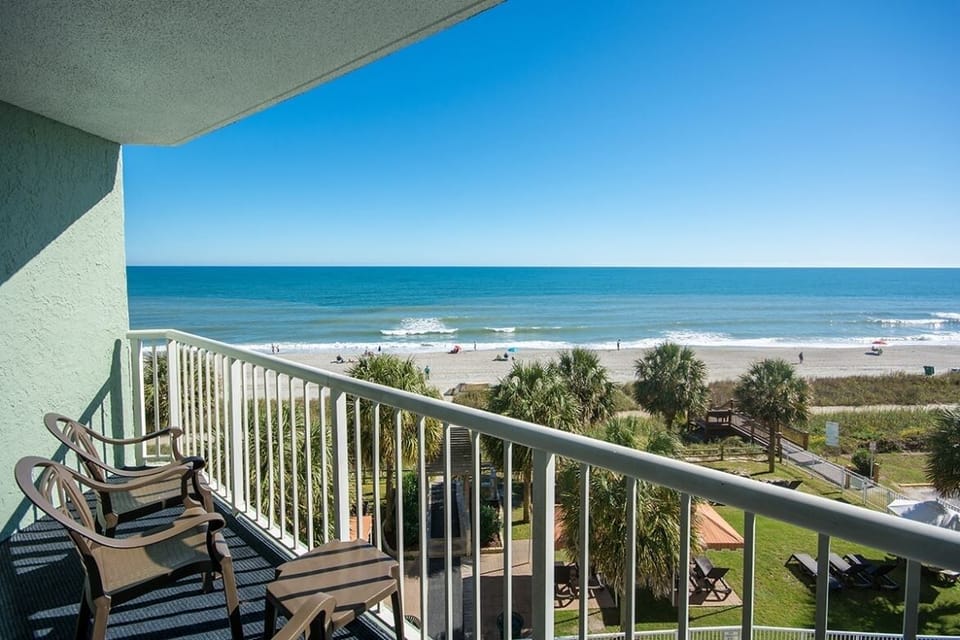 Sip morning coffee on the balcony above the beach.