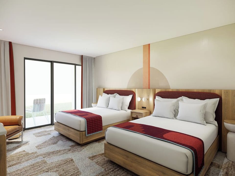 Settle into plush double-queen comfort with breezy balcony light