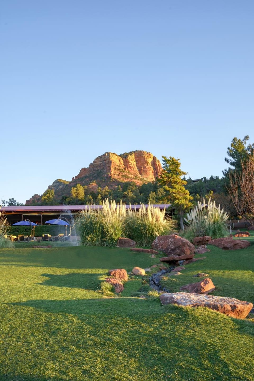 Breathe deeply with wide-open greens framed by red cliffs.