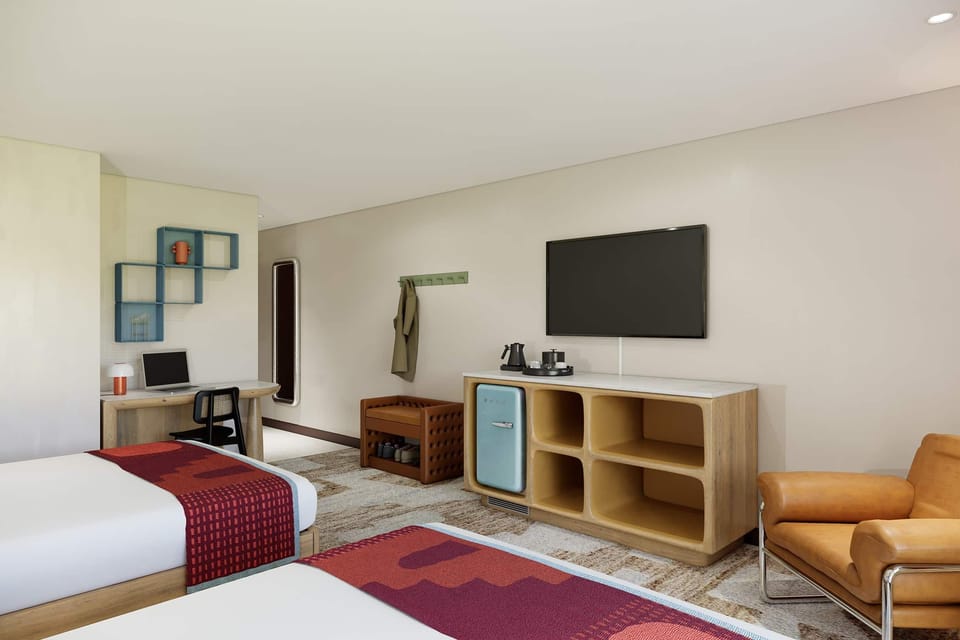Settle in with a workstation, TV lounge, and mini fridge.
