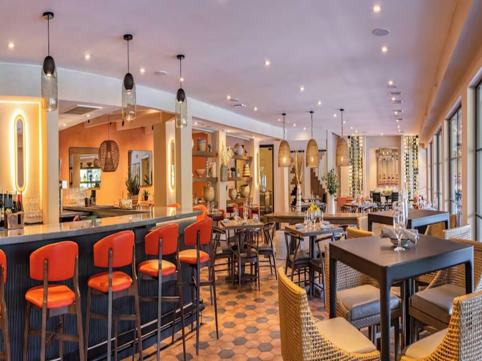 Sip craft cocktails at the glowing bar before dinner.
