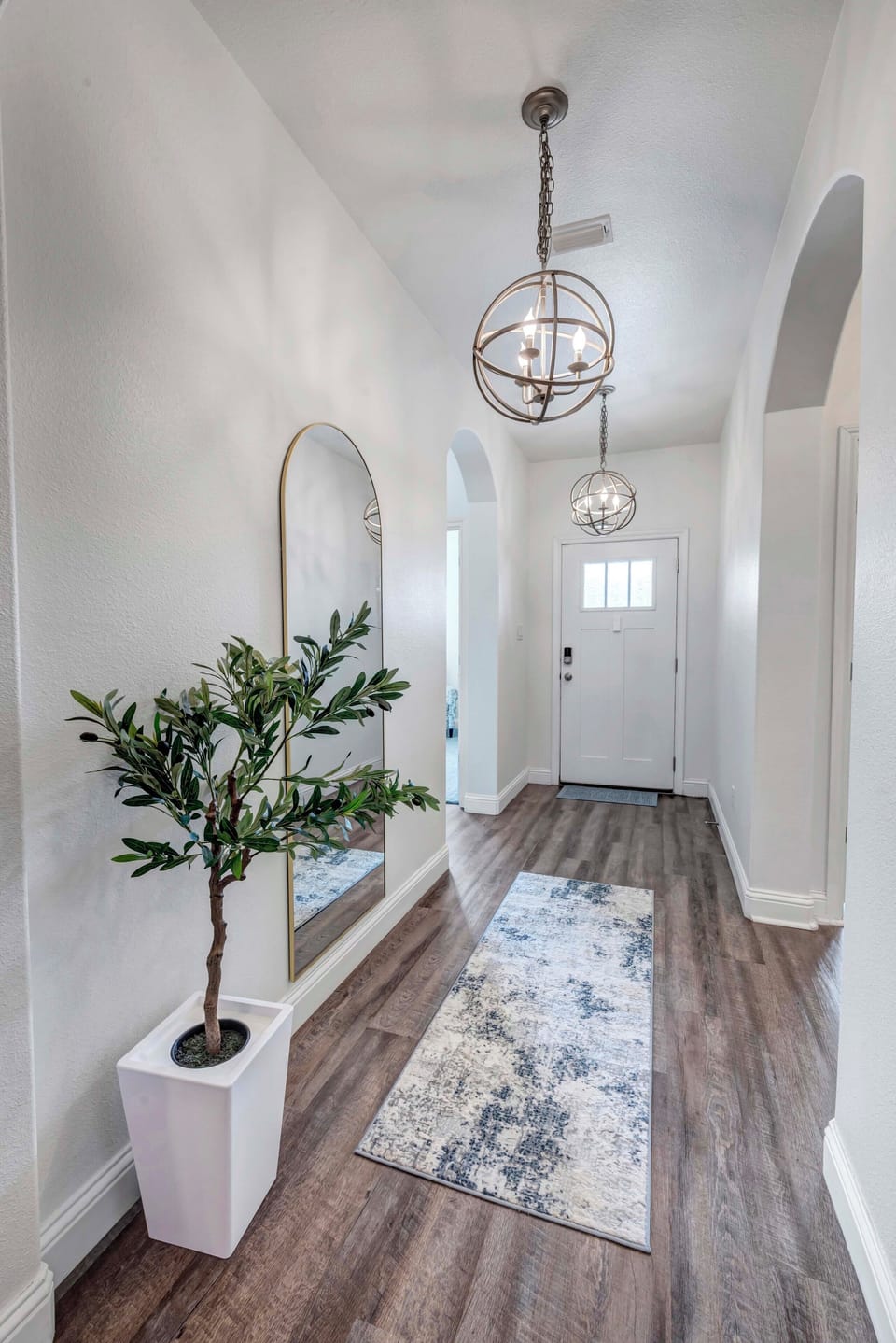 Welcoming entry with bright open hallway.