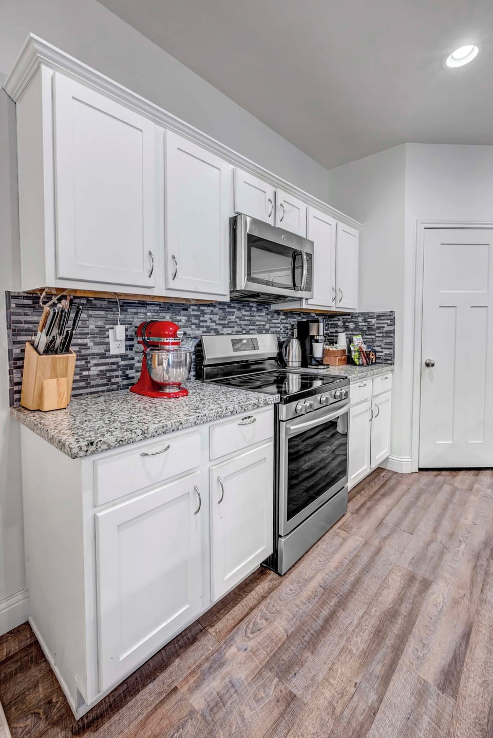 Kitchen stocked with cookware and appliances.
