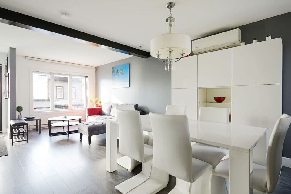 Bright dining and living area filled with natural sunlight.