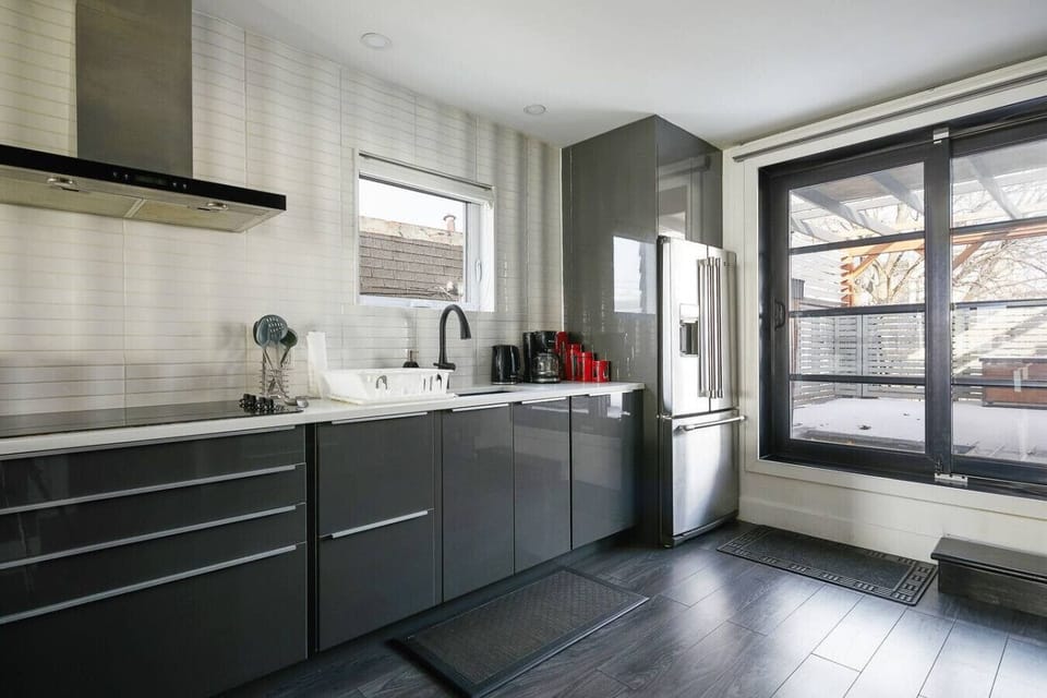Stylish kitchen featuring a French-door refrigerator and ceramic cooktop.