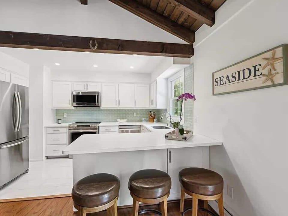 Kitchen breakfast bar with seating for three and coastal decor