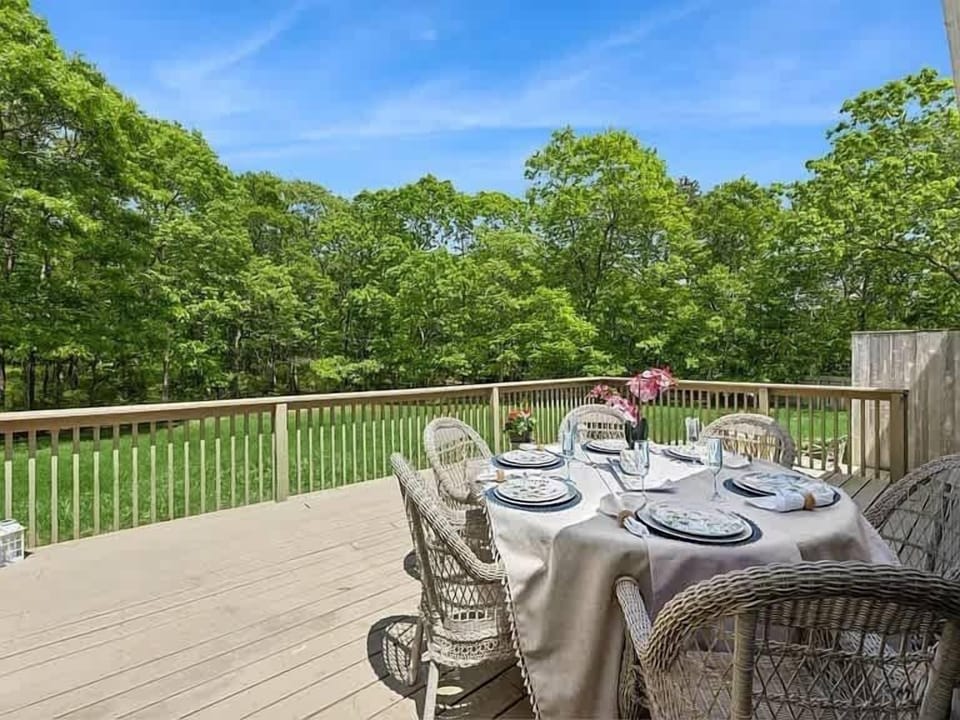 Spacious deck with al fresco dining surrounded by mature trees