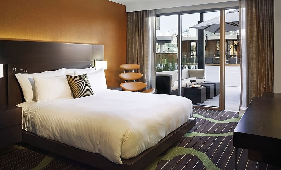 Unwind in a plush bed with private terrace lounging.