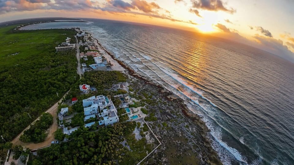 Breathtaking aerial view of the villa at sunset. Beachfront villa surrounded by impressive nature.
